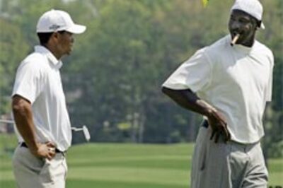 Basketball great tees off with Tiger