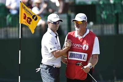 Johnson leads British Open while Woods lurks three shots back