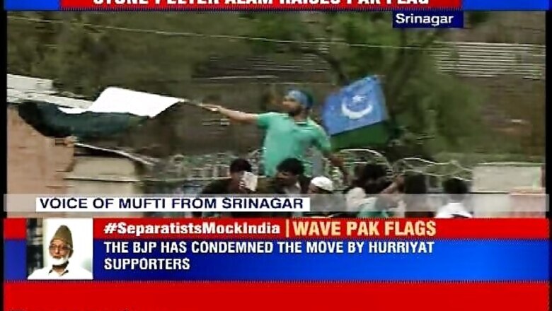 Kashmiri separatist leader Masarat Alam waves Pakistani flag to greet Syed Ali Geelani in Srinagar