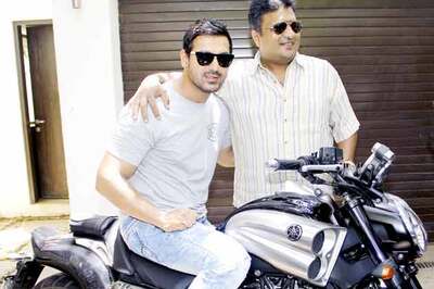 Snapshot: John Abraham gifts a bike to Sanjay Gupta