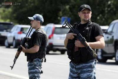 EU agrees first broad sanctions on Russia; Ukraine fighting kills dozens