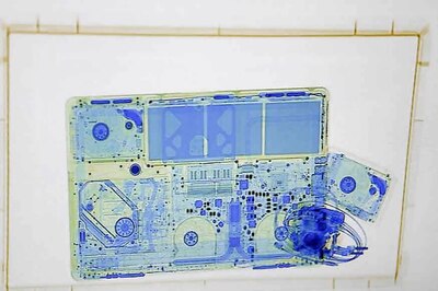 Passengers Waiting to Collect Their Possessions Find a Woman Crawling out of X-Ray Machine